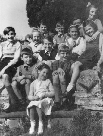 Castlethorpe children seated by the War Memoria