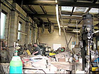 Oliver in the workshop he now shares with his father