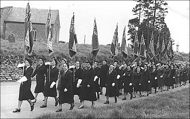 Castlethorpe Women's British Legion. Front row (behind the lead standard bearer): Left - right: Rene West, Mary Keeves (carrying the Castlethorpe banner) , Minnie Cowley