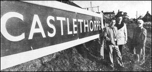 Beside the railway station board: Bert Tapp, parish council chairman, Norman West, vice-chairman, and Charles Clayton, clerk.