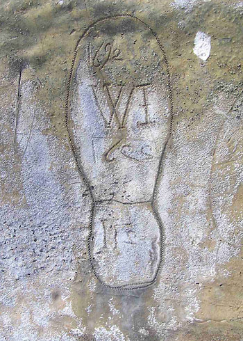 carved face with angel wings