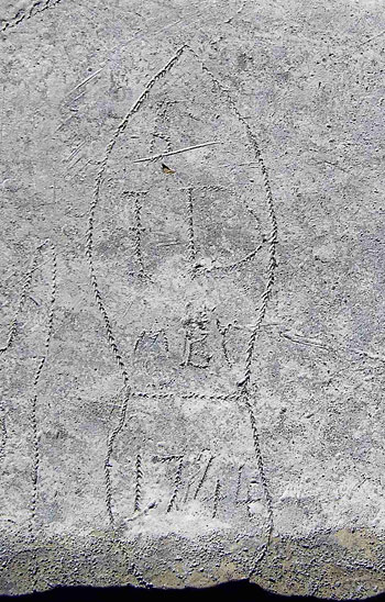carved face with angel wings