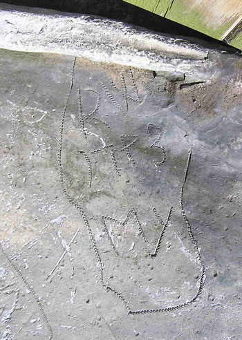 carved face with angel wings