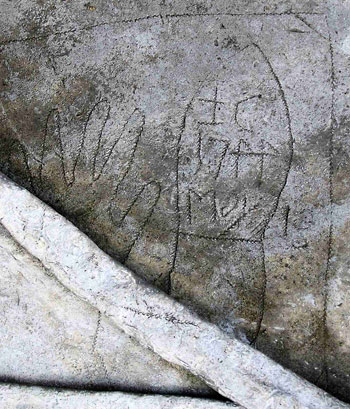 carved face with angel wings