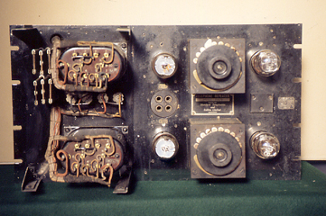 Front view of a Repeater Panel. Built on a 19'' x 10.5'' steel panel, each repeater weighed 50lbs. It shows the typical construction of the equipment at that time. The maximum gain of this example of a repeater is 42db. Gain adjustment was achieved by altering the position of the grid tap on the input transformer secondary winding. This gave coarse adjustment of around 5db per tap. Whilst fine adjustment was achieved by altering the grid tap on the inter stage transformer, these taps were wired out to a large rotary stud switch. This gave an adjustment of 1db per tap.