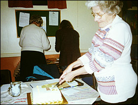 Nora Chapman cutting the anniversary cake