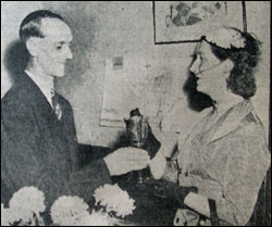 Bill Scripps receiving the cup from Pat St. John 