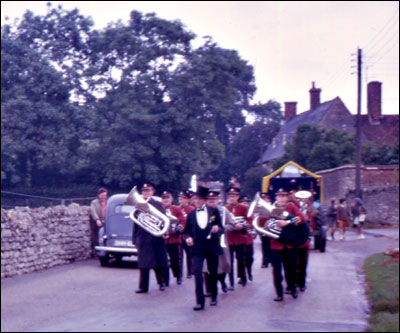 Tom West parade marshal, with the New Bradwell Band marching down South Street, Castlethorpe