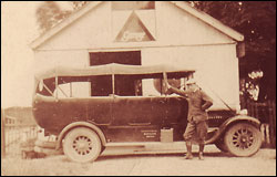Mr. Bellham standing by his charabanc