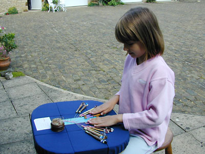 Young generation at work on a lace snake design
