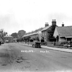 High Street with the old Cock Inn on the right and the Watts Arms at the end of the street. c.1925