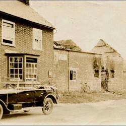 The Globe in 1924 after fire had destroyed part of the roof, John Rainbow's (the publican) car.