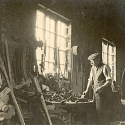 Fred Wesley, the village wheelwright, in his workshop  c.1930.