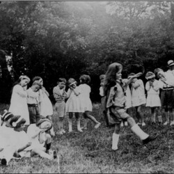 School children dancing in Grid Iron field behind the school (now the village hall) in Newport Road, 1924/25