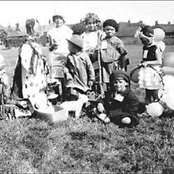 Children in costume in a field behind High Street, c.1920