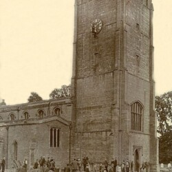 Tom Courtman up the tower, fixing the hands in place, 1904