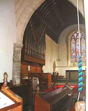 View from the choir stalls towards the organ - note the bell rope