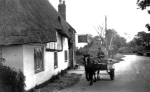 A cart passes the Swan in about 1960 with James Stanniforth