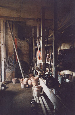 Interior of potting shed. The boiler house is through the brick arch